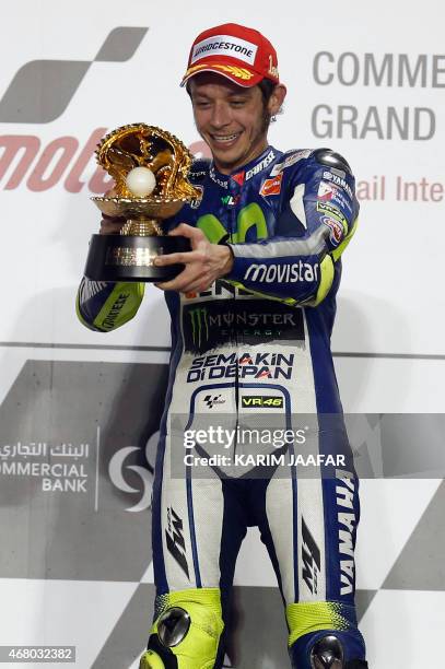 Movistar Yamaha MotoGP rider Valentino Rossi of Italy celebrates with his trophy on the podium after winning the MotoGP race of the Qatar Grand Prix...