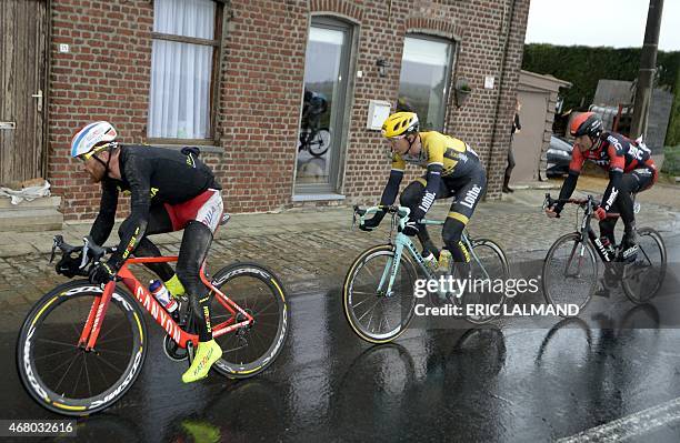 Italian Luca Paolini of Team Katusha, Belgian Sep Vanmarcke of Team LottoNL-Jumbo and Italian Daniel Oss of BMC Racing Team ride past during the 77th...