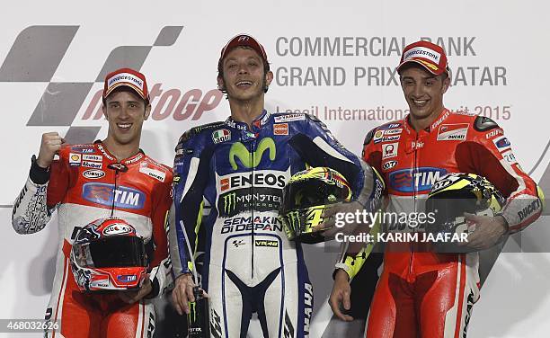 Movistar Yamaha MotoGP rider Valentino Rossi of Italy celebrates with Andrea Iannone of Italy and Andrea Dovizioso of Italy on the podium after...