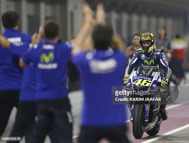 Italian MotoGP rider Valentino Rossi of the Movistar Yamaha team celebrates with teammates after winning the MotoGP race of the Qatar Grand Prix...