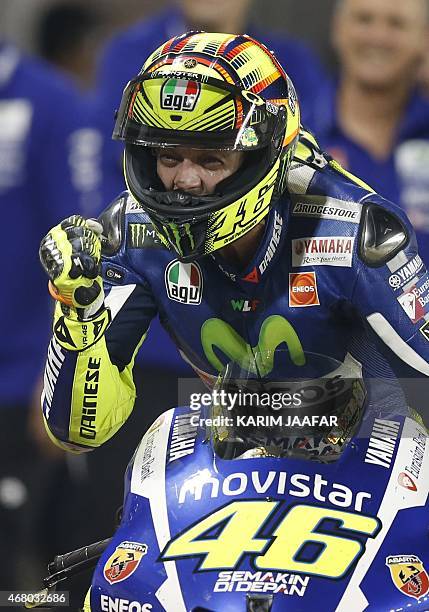 Italian MotoGP rider Valentino Rossi of the Movistar Yamaha team gestures after winning the MotoGP race of the Qatar Grand Prix Grand Prix on March...