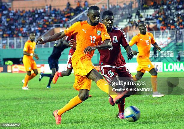 Equatorial Guinea's player Armando Sipoto Bonale unvies with Ivory Coast's Jean Daniel Akpa Akpro during the friendly football match Ivory Coast...
