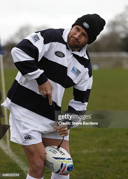 Matt Giteau of Australia pumps up rugby balls during the launch of the Land Rover Rugby World Cup 2015 "We Deal In Real" campaign at a grassroots...