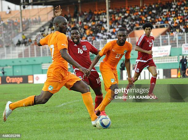 Equatorial Guinea's Armando Sipoto vies with Ivory Coast's Jean-Daniel Akpa Akpro and Sio Giovani during the friendly football match Ivory Coast...