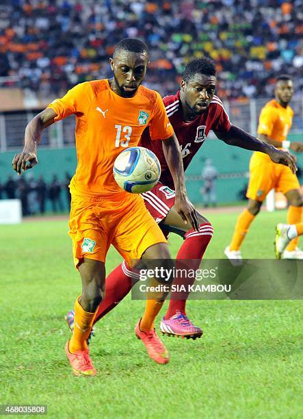 Equatorial Guinea's Armando Sipoto Bonale vies with Ivory Coast's Jean Daniel Akpa Akpro during the friendly football match Ivory Coast againt...