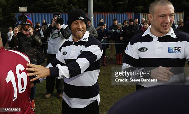Land Rover ambassador Jonny Wilkinson and Mike Brown clap the teams off the pitch during the launch of the Land Rover Rugby World Cup 2015 "We Deal...