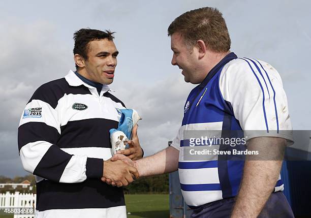Land Rover ambassador Bryan Habana shakes hands and presents a pair of his playing boots to the Racal Decca RFC captain Sean Phelan during the launch...