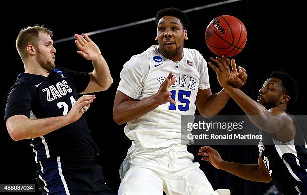 Jahlil Okafor of the Duke Blue Devils loses control of the ball as Przemek Karnowski and Byron Wesley of the Gonzaga Bulldogs defend in the first...