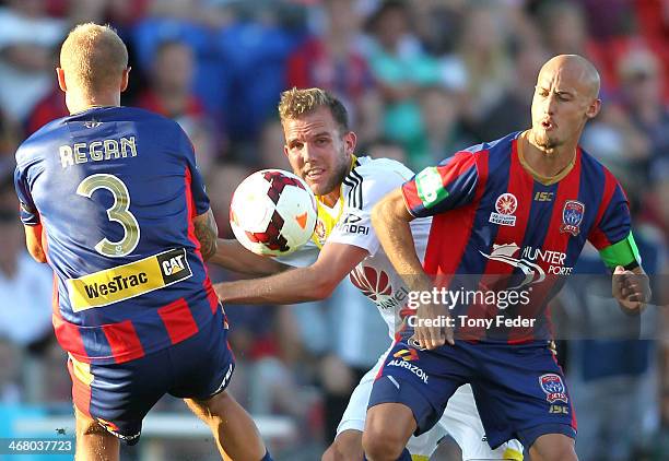 Jeremy Brockie of the Phoenix contests the ball with Taylor Regan and Ruben Zadkovich of the Jets during the round 18 A-League match between the...