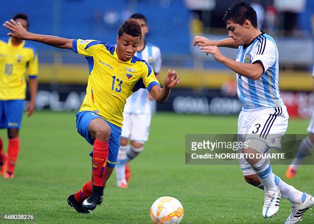 Byron Castillo , of Ecuador and Luis Olivera, of Argentina, vie for the ball during their U-17 South American final round football match at Feliciano...