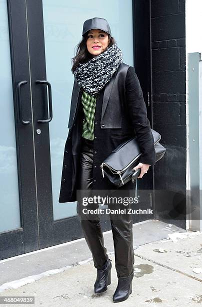 April Hennig is seen outside the Christian Siriano show wearing an Alexander Wang jacket, a Kenzo sweater, J. Brand leather pants, Proenza Schouler...