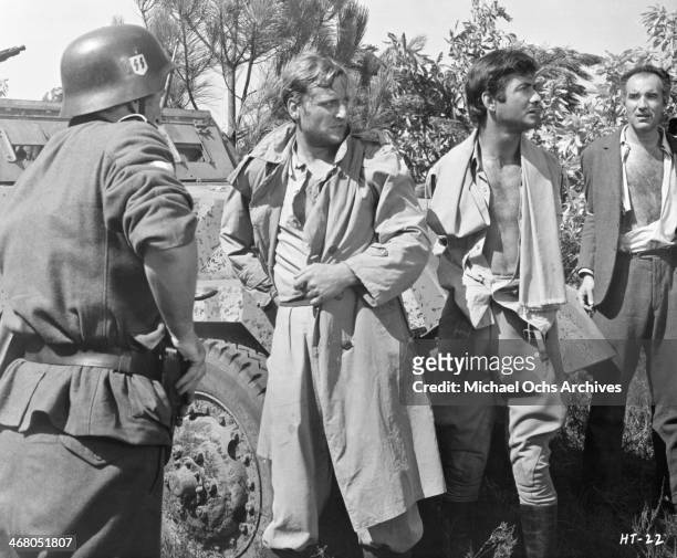 Actors Bruno Cremer, Jean-Claude Brialy and Michel Piccoli on set of the movie "Shock Troops" , circa 1967.