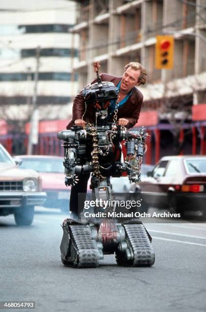Actor Michael McKean with Johnny Five on set of the movie "Short Circuit 2", circa 1988.