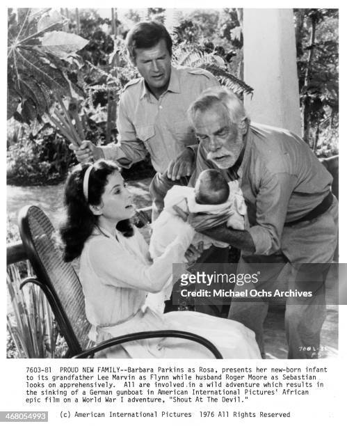 Actress Barbara Parkins and actors Lee Marvin and Roger Moore on set of the movie "Shout at the Devil " , circa 1976.