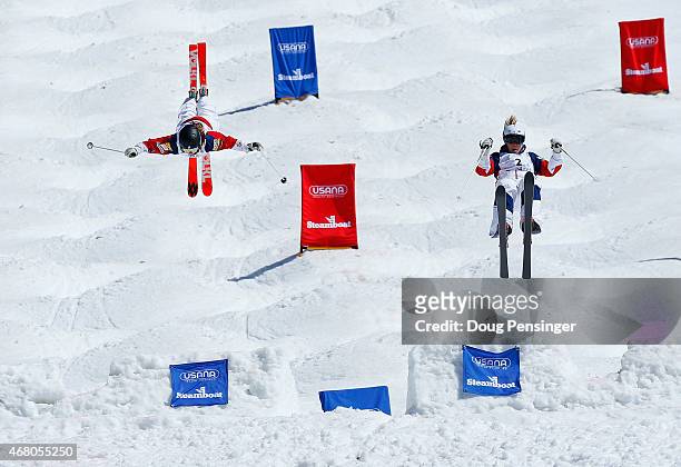 Nessa Dziemian skis to victory against second place finisher K C Oakley as they go airborne off the last jump in the ladies' final of dual moguls at...