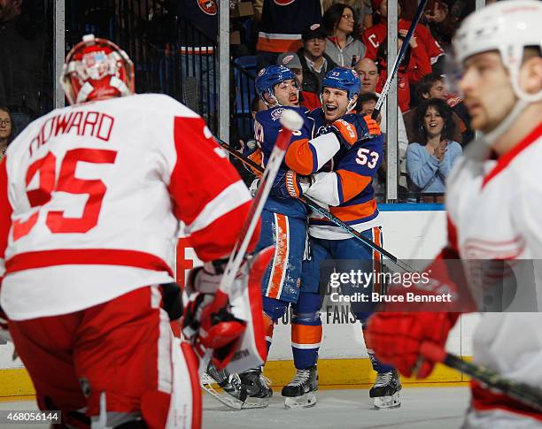 Cal Clutterbuck of the New York Islanders celebrates his shorthanded goal at 3:57 of the second period against Jimmy Howard of the Detroit Red Wings...