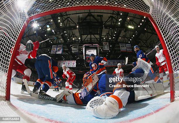 Shot by Pavel Datsyuk of the Detroit Red Wings gets past Jaroslav Halak of the New York Islanders at 10:13 of the second period at the Nassau...