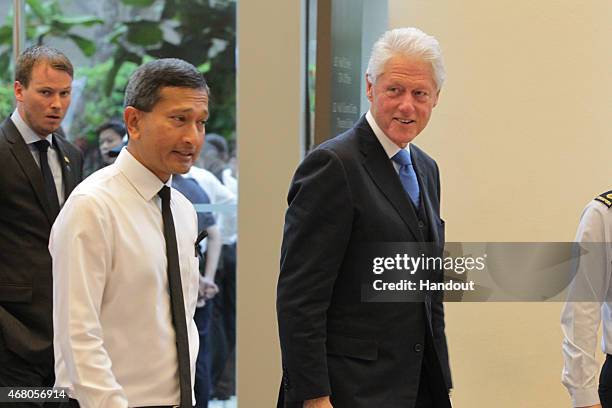 In this handout image provided by the Ministry of Communications and Information of Singapore, Former President Bill Clinton attends the funeral of...