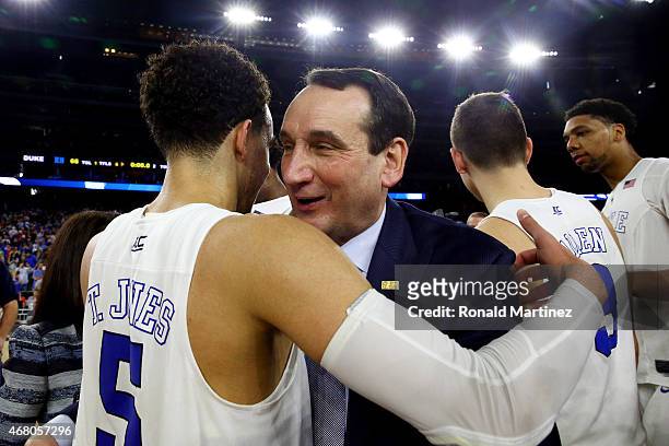 Head coach Mike Krzyzewski hugs Tyus Jones of the Duke Blue Devils after defeating the Gonzaga Bulldogs 66-52 during the South Regional Final of the...