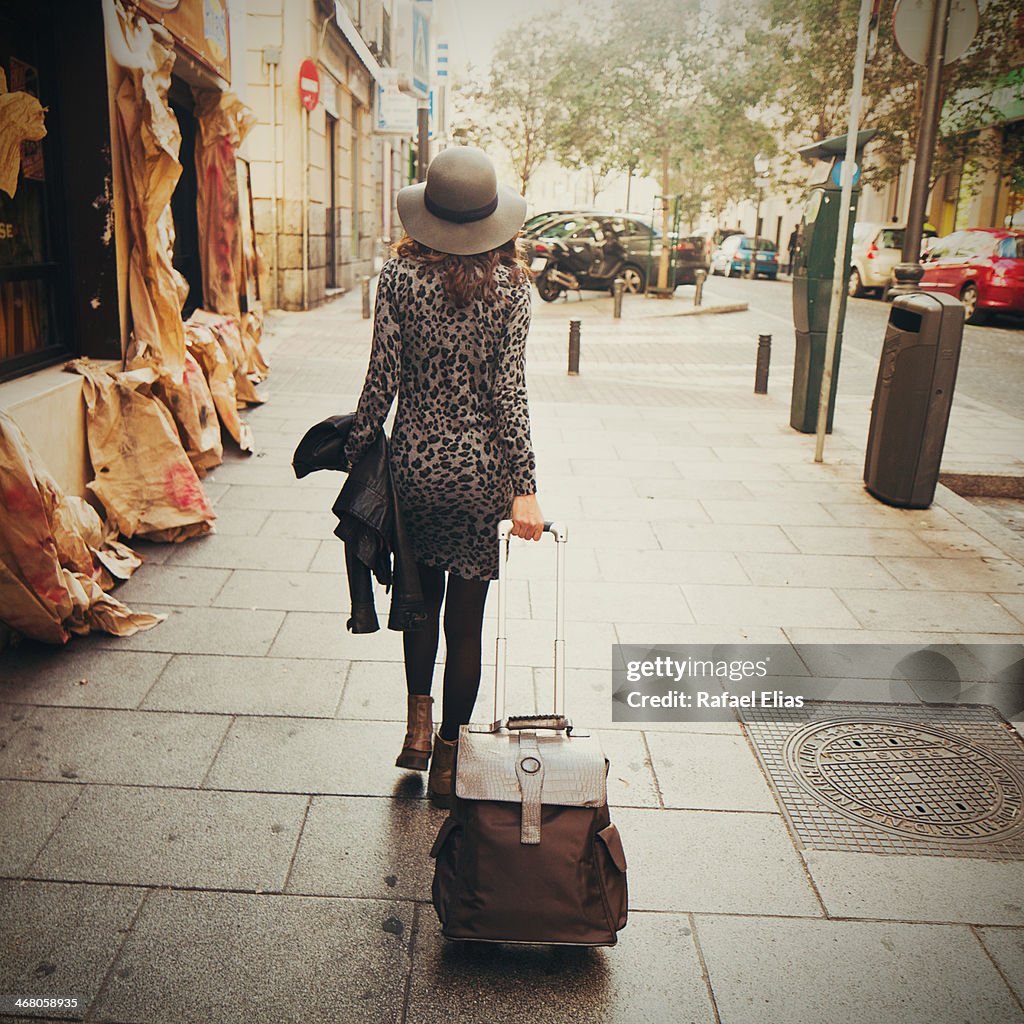 Woman walking with luggage