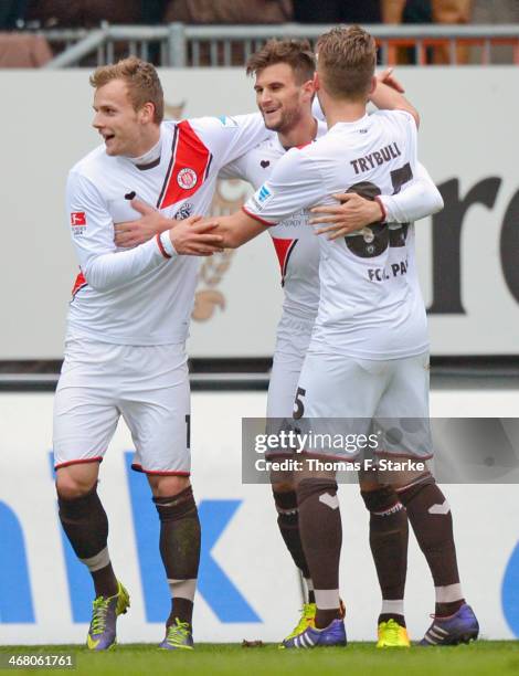 Lennart Thy, Christopher Noethe and Tom Trybull of St. Pauli celebrate their teams second goal during the Second Bundesliga match between Arminia...