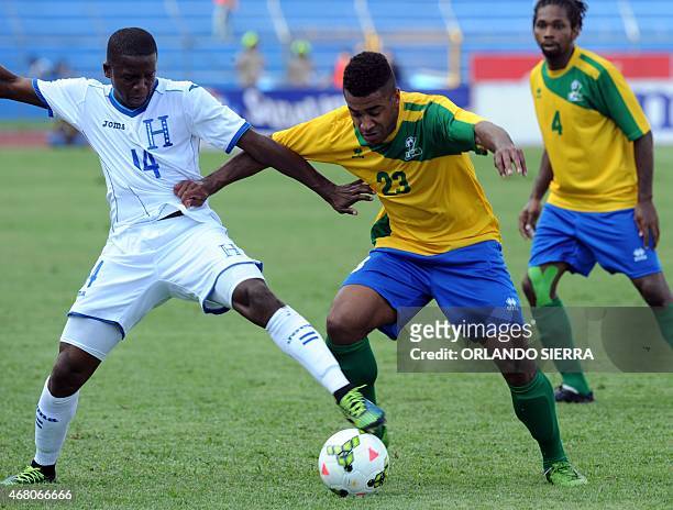 Honduras' Bonieck Garcia vies for the ball with David Legrand of French Guiana during the Concacaf Gold Cup qualifying playoff match, at the Olimpico...