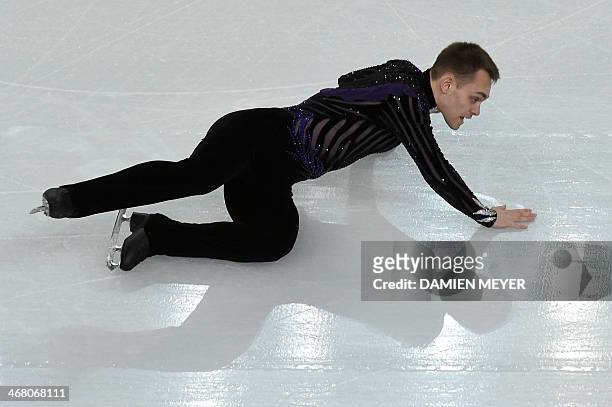 Italy's Paul Bonifacio Parkinson falls as he performs in the Men's Figure Skating Team Free Program at the Iceberg Skating Palace during the Sochi...