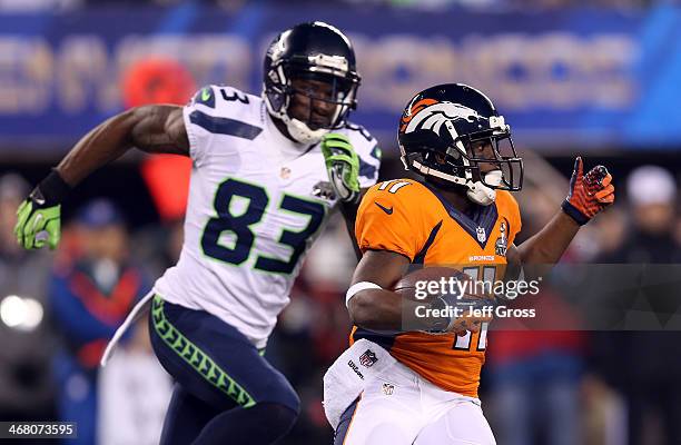 Wide receiver Trindon Holliday of the Denver Broncos tries to avoid the tackle of wide receiver Ricardo Lockette of the Seattle Seahawks during Super...