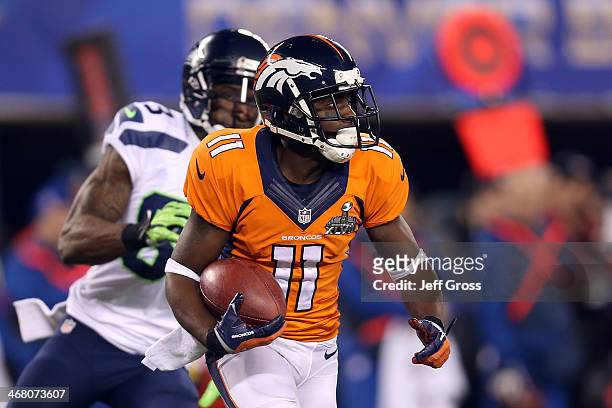 Wide receiver Trindon Holliday of the Denver Broncos tries to avoid the tackle of wide receiver Ricardo Lockette of the Seattle Seahawks during Super...