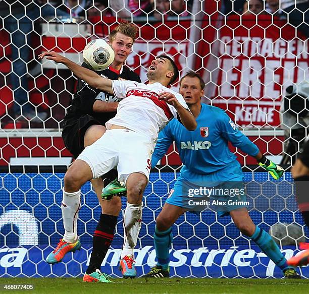 Vedad Ibisevic of Stuttgart is challenged by Jan-Ingwer Callsen-Bracker and goalkeeper Alexander Manninger of Augsburg during the Bundesliga match...