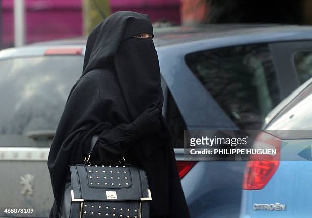Woman wearing a niqab, a type of full veil, as she walks in a street in the center of Roubaix, on January 9, 2014. AFP PHOTO / PHILIPPE HUGUEN