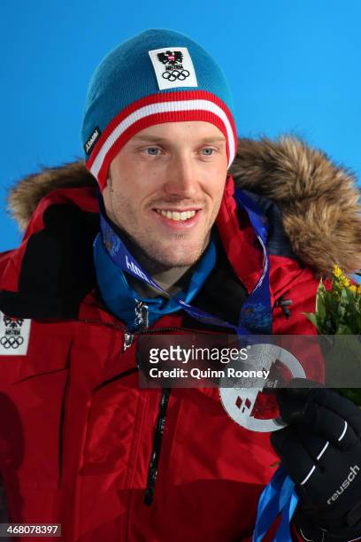 Silver medalist Dominik Landertinger of Austria celebrates during the medal ceremony for the Men's Sprint 10 km on day 2 of the Sochi 2014 Winter...