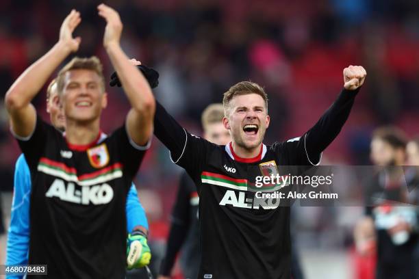 Matthias Ostrzolek and Daniel Baier of Augsburg celebrate after the Bundesliga match between VfB Stuttgart and FC Augsburg at Mercedes-Benz Arena on...