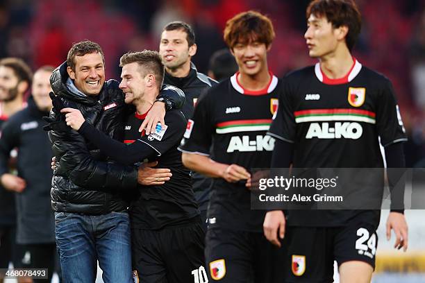 Head coach Markus Weinzierl of Augsburg hugs Daniel Baier after the Bundesliga match between VfB Stuttgart and FC Augsburg at Mercedes-Benz Arena on...