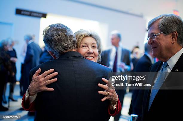 Former Sen. Kay Bailey Hutchison, R-Texas, hugs former Sen. Tom Daschle, D-S.D., as former Sen. Trent Lott, R-Miss., looks on during a gala that was...