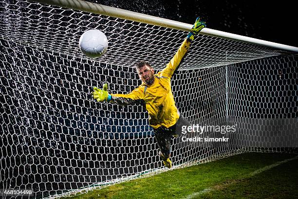 soccer goalie jumping for ball - shootout stock pictures, royalty-free photos & images