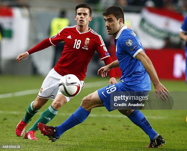 Zoltan Stieber of Hungary fights for the ball with Sokratis Papastathopoulos of Greece during their Euro 2016 qualification soccer match at Grupama...