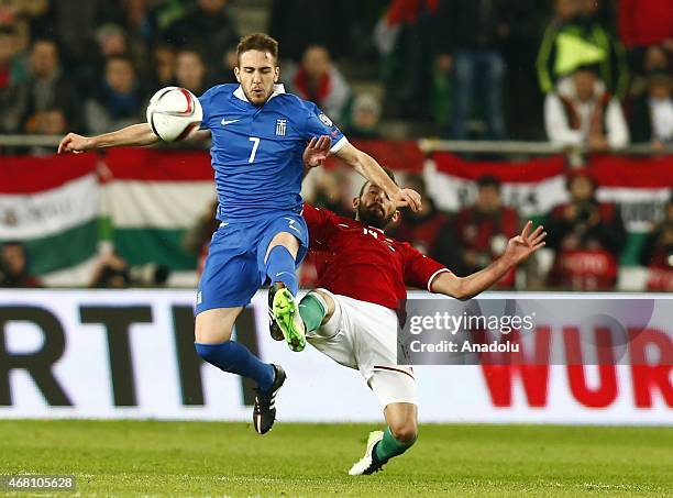 Attila Fiola of Hungary is challenged by Kostas Fortounis of Greece during Hungary v Greece European Euro 2016 qualification soccer match at Grupama...