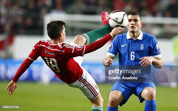 Zoltan Stieber of Hungary is challenged by Panagiotis Papadopoulos of Greece during Hungary v Greece European Euro 2016 qualification soccer match at...