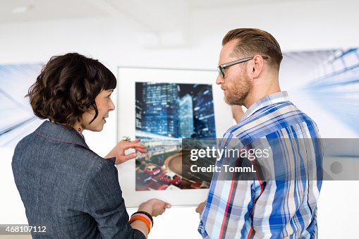 Artist Showing Female Gallery Owner His Work Artist Showing Female Gallery Owner His Work