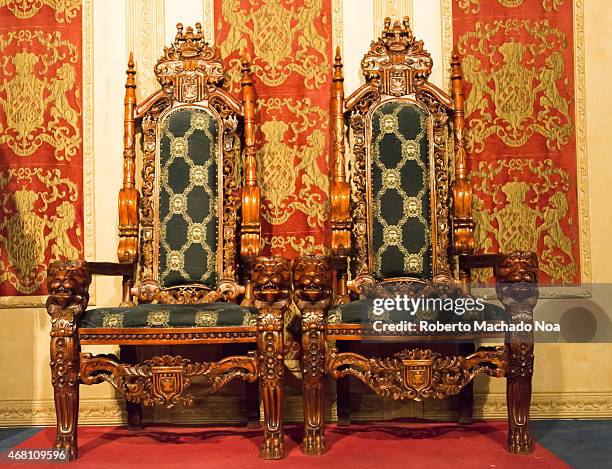 Beautiful luxurious medieval wooden seats in a castle hall, possible where lord and lady sit.