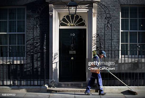 Street sweeper cleans the pavement in front of 10 Downing Street on March 30, 2015 in London, England. Campaigning in what is predicted to be...