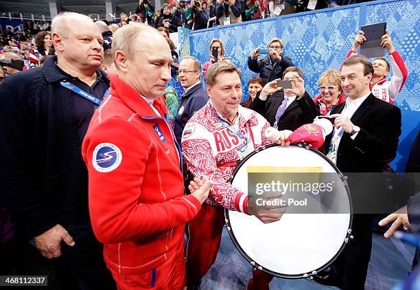 Russian President Vladimir Putin walks through the arena after the Flower Ceremony for the Team Figure Skating Overall during day two of the Sochi...