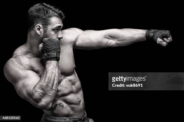 powerful fighter - mixed martial arts stock pictures, royalty-free photos & images