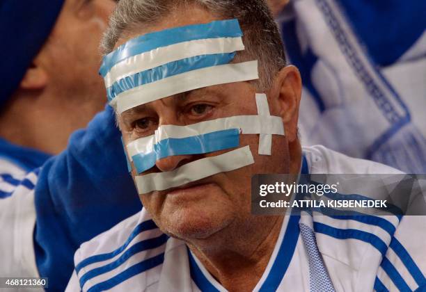 Greek fan reacts in the Grupama Arena in Budapest prior to an Euro 2016 qualifying football match between Hungary and Greece on March 29, 2015. AFP...