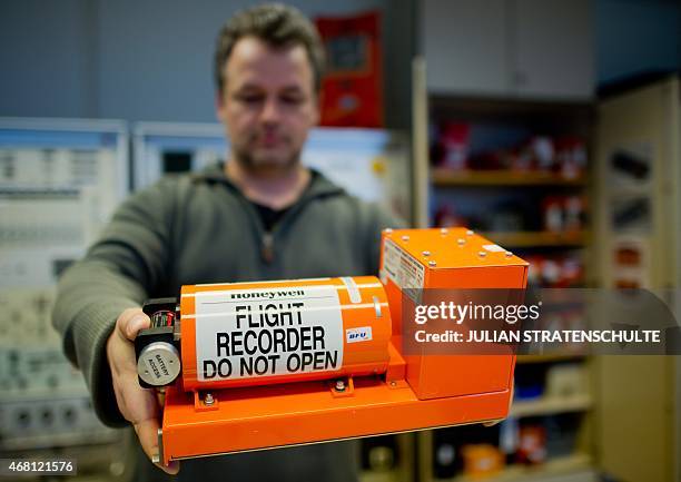 Jens Friedemann holds a flight recorder at the German Federal Bureau of Aircraft Accident Investigation in Braunschweig, central Germany, on March...