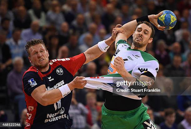 Lars kaufmann of Flensburg is challenged byTim Kneule of Goeppingen during the DKB Bundesliga handball match between SG Flensburg-Handewitt and FA...