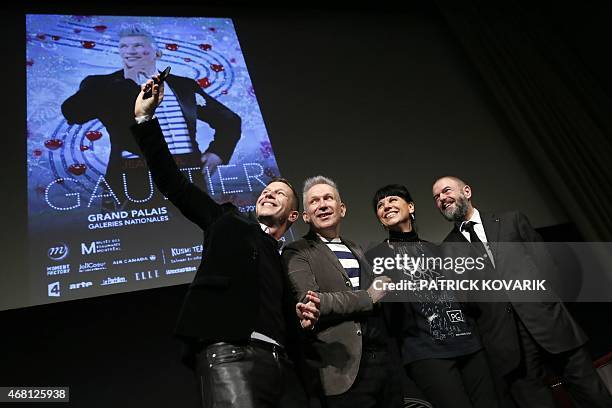 French fashion designer Jean-Paul Gaultier , flanked by The Grand Palais Museum president Jean-Paul Cluzel , the curator of museum des Beaux arts of...