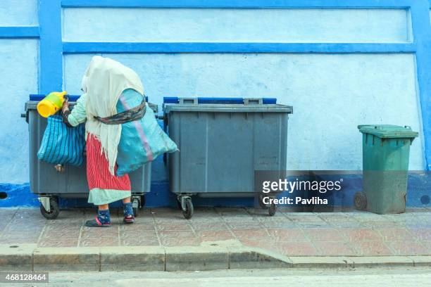 old moroccan women looking in the trash, chefchaouen, morocco - hiding rubbish stock pictures, royalty-free photos & images