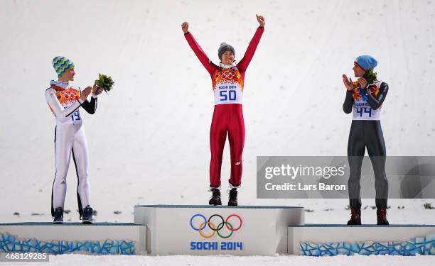 Silver medalist Peter Prevc of Slovenia, gold medalist Kamil Stoch of Poland and bronze medalist Anders Bardal of Norway celebrate on the podium...